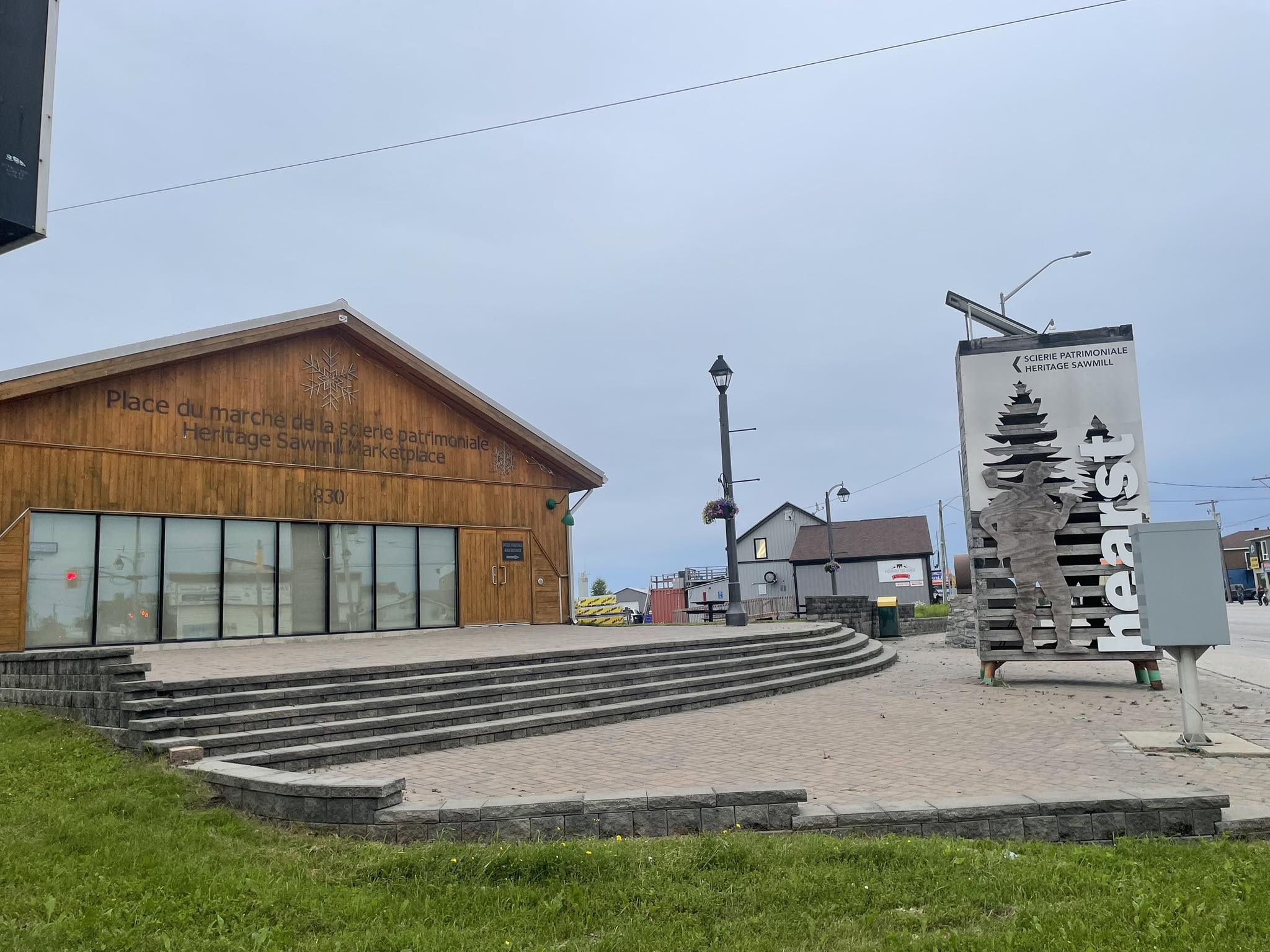 Manicured landscape with lush green lawn and stone retaining wall by Lafleur Gardens