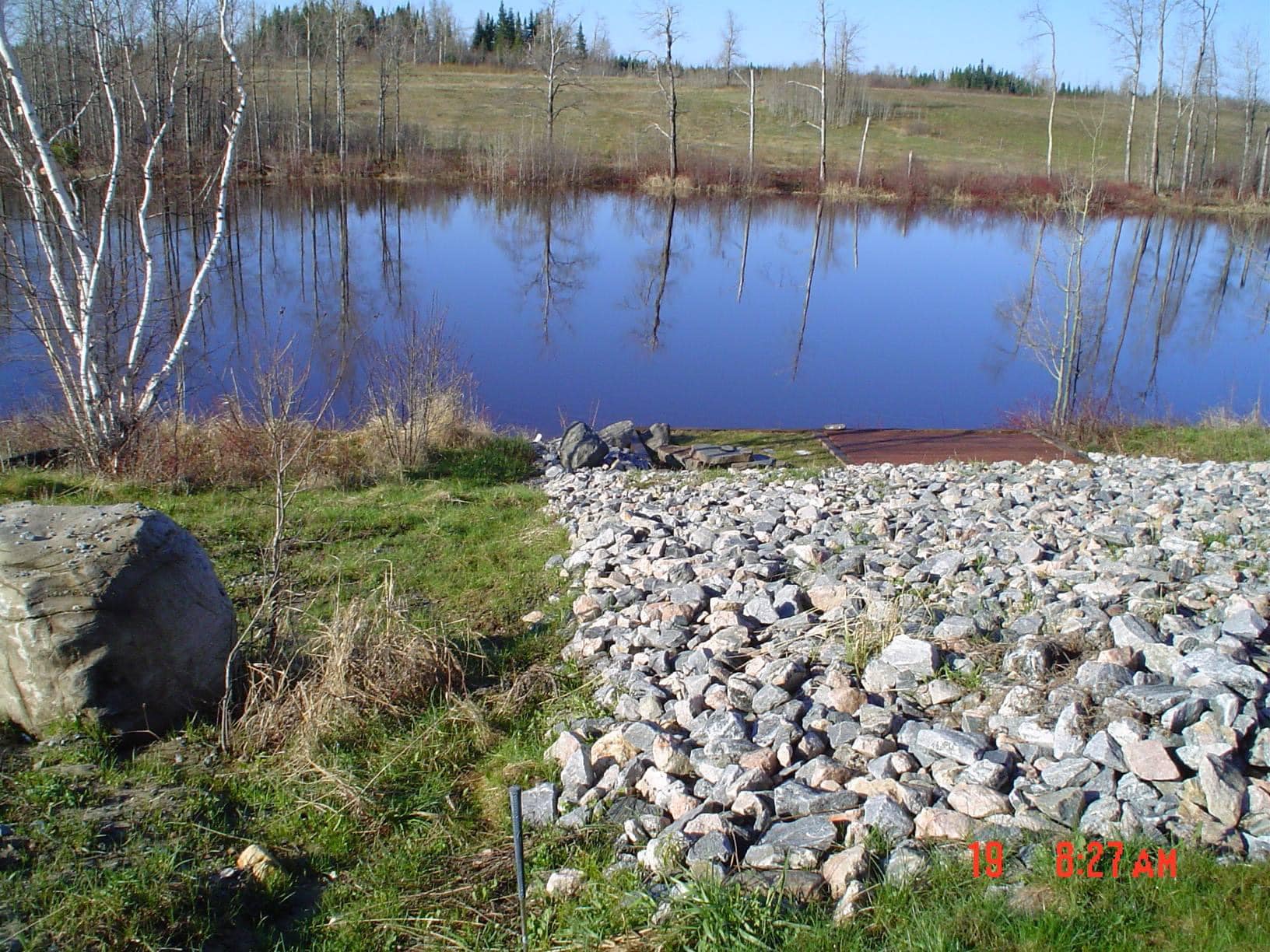 Backyard landscaping with lawn and garden beds